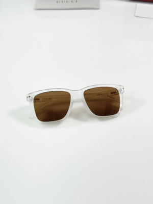 Guccii 2417 Ice Brown sunglasses with a translucent white frame and brown-tinted lenses